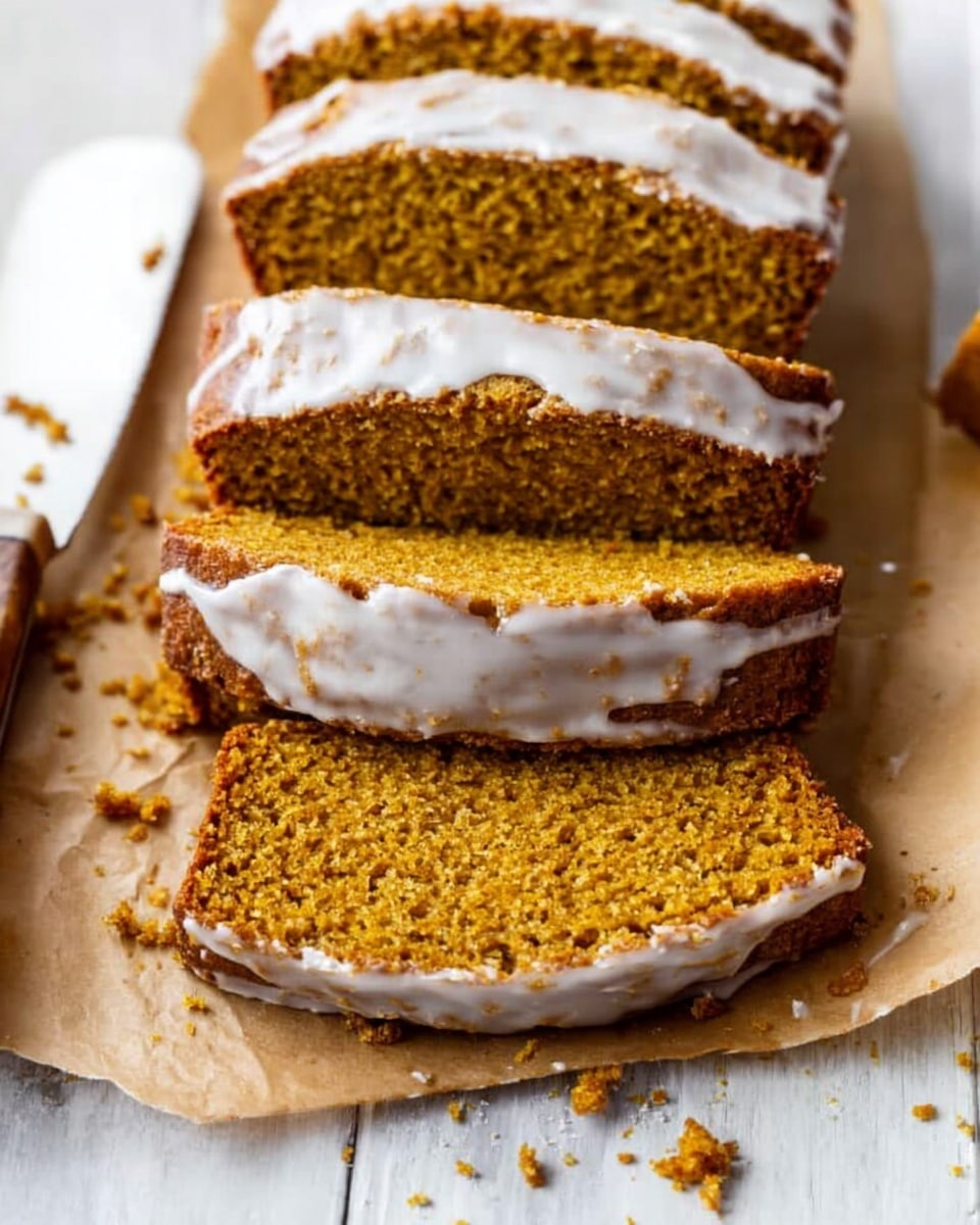 The image shows four slices of moist pumpkin bread lined up on top of each other, placed on brown parchment paper over a wooden board. Each slice is topped with a thick layer of shiny white icing that contrasts with the deep orange-brown of the bread. The texture of the bread looks soft and slightly crumbly with small bits visible inside. A white knife with some crumbs rests to the left side on the parchment paper. The background is a white marbled surface. photo taken with an iphone --ar 4:5 --v 7