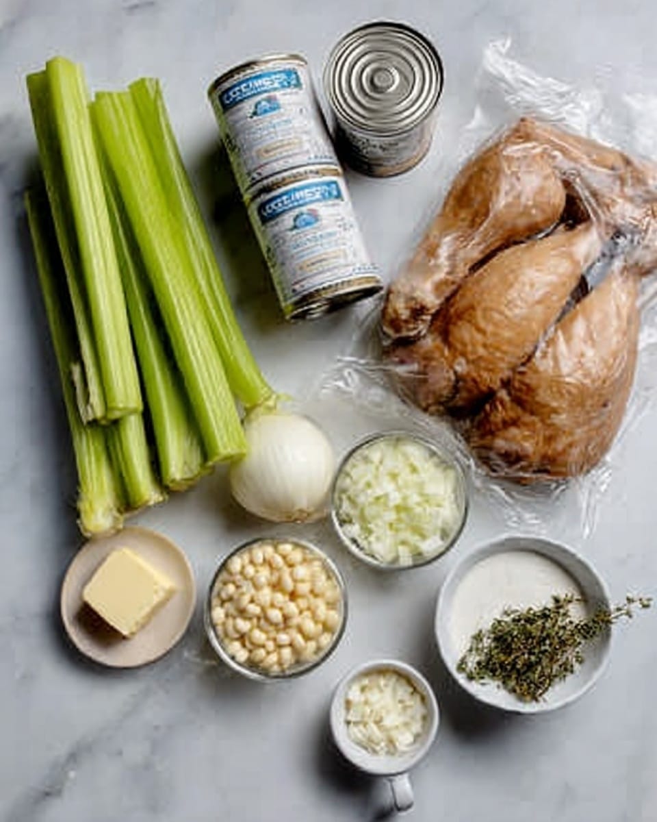 The image shows several cooking ingredients placed neatly on a white marbled surface. At the top right, there is a plastic bag with cooked, dark brown meat. Next to it on the left are three cans; two have a white and blue label, and the third has a white label. Below these cans, three fresh celery sticks with bright green color lay side by side. To the right of the celery and below the meat, there are several small cubes of yellow bouillon in a small container. Next to this, a white bowl is filled with finely chopped white onions. Below the onions is a white measuring cup filled with slightly crumbly white cheese. To the left of the cheese is a small clear glass bowl with minced garlic. Below the garlic is a block of pale yellow butter, and next to it is a small pile of white pepper and black pepper in a white bowl. The overall arrangement is clean and organized, with soft natural lighting highlighting the textures of each item. photo taken with an iphone --ar 4:5 --v 7