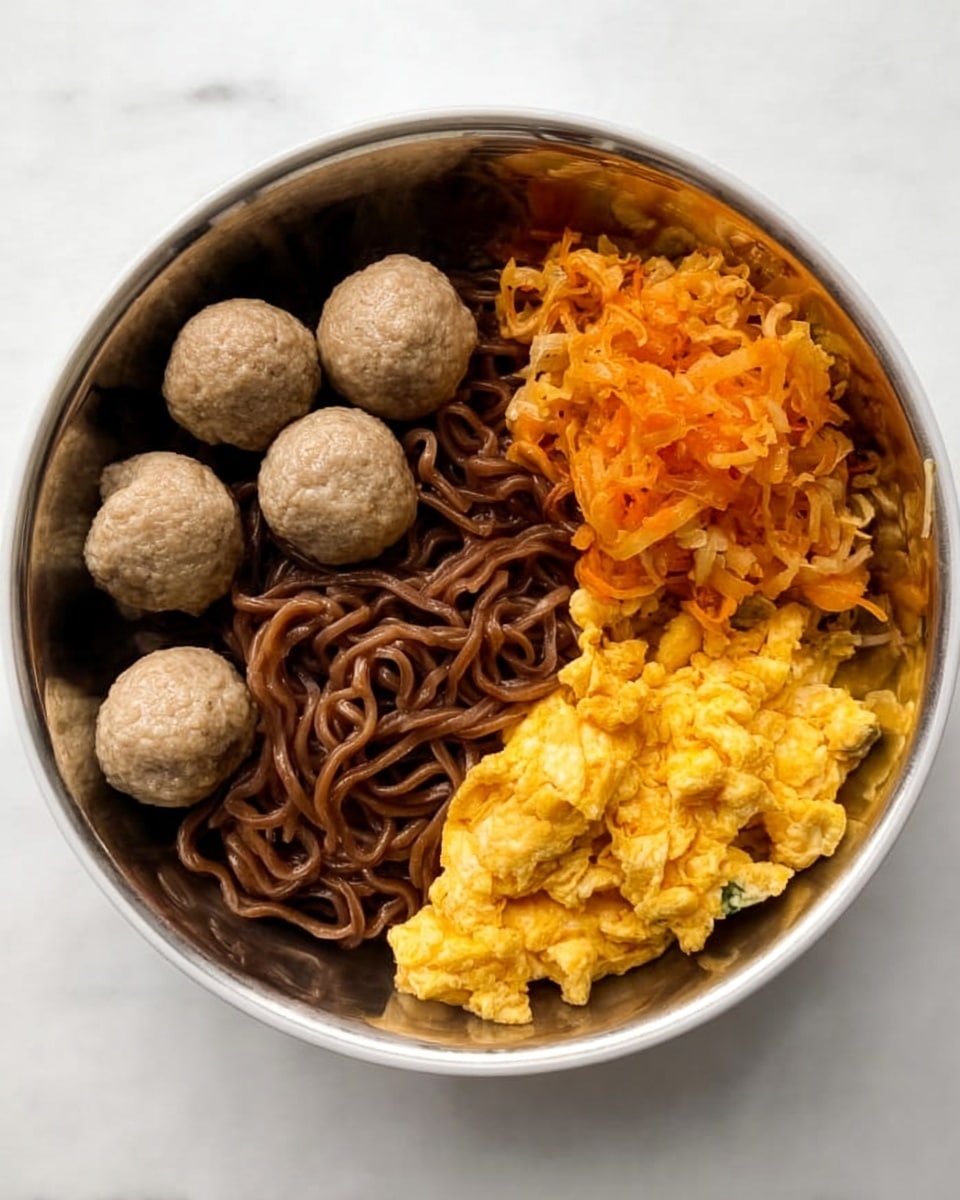 The image shows a white bowl filled with three main layers arranged side by side. On the left, there are four evenly spaced round greyish meatballs with a smooth texture. In the center, there is a serving of dark brown noodles that look slightly shiny and twisted together. On the right, there is a layer of cooked scrambled eggs with a bright yellow and orange color, having a soft and fluffy texture. The bowl is placed on a white marbled surface. Photo taken with an iphone --ar 4:5 --v 7