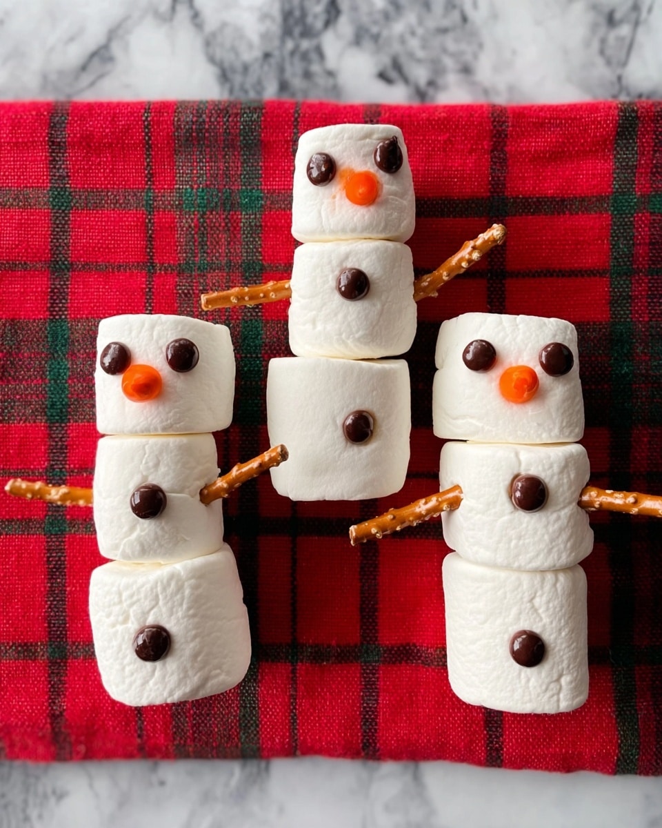 The image shows a white bowl on the right side filled with large white marshmallows with a smooth texture. Above the bowl is a small bunch of wooden skewers and toothpicks. To the left, there are two small white bowls stacked vertically, the top one filled with round dark chocolate discs and the bottom one with round white chocolate discs, both having flat shiny surfaces. On the far left, there is a white plate holding multiple small chocolate candies shaped like flowers, a piece of orange candy, and two rolled strips of brown fruit leather. Below the plate are several thin, crunchy pretzel sticks placed on the white marbled surface. photo taken with an iphone --ar 4:5 --v 7