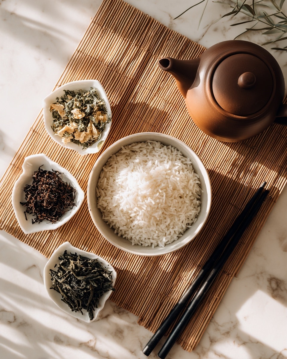 A white bowl filled with fluffy white rice is placed at the center on a light brown bamboo mat, surrounded by four small white dishes each containing different kinds of tea leaves; the top left dish has mixed green and beige dried leaves, the bottom left dish holds dark brown dried leaves, the bottom center dish contains dark green needle-like leaves, and the bottom right dish has black thin sticks of tea leaves. To the right of the rice bowl, a pair of black chopsticks rests on the mat near a brown teapot with a smooth, round shape. The whole scene sits on a white marbled surface with soft natural light shining from the left photo taken with an iphone --ar 4:5 --v 7