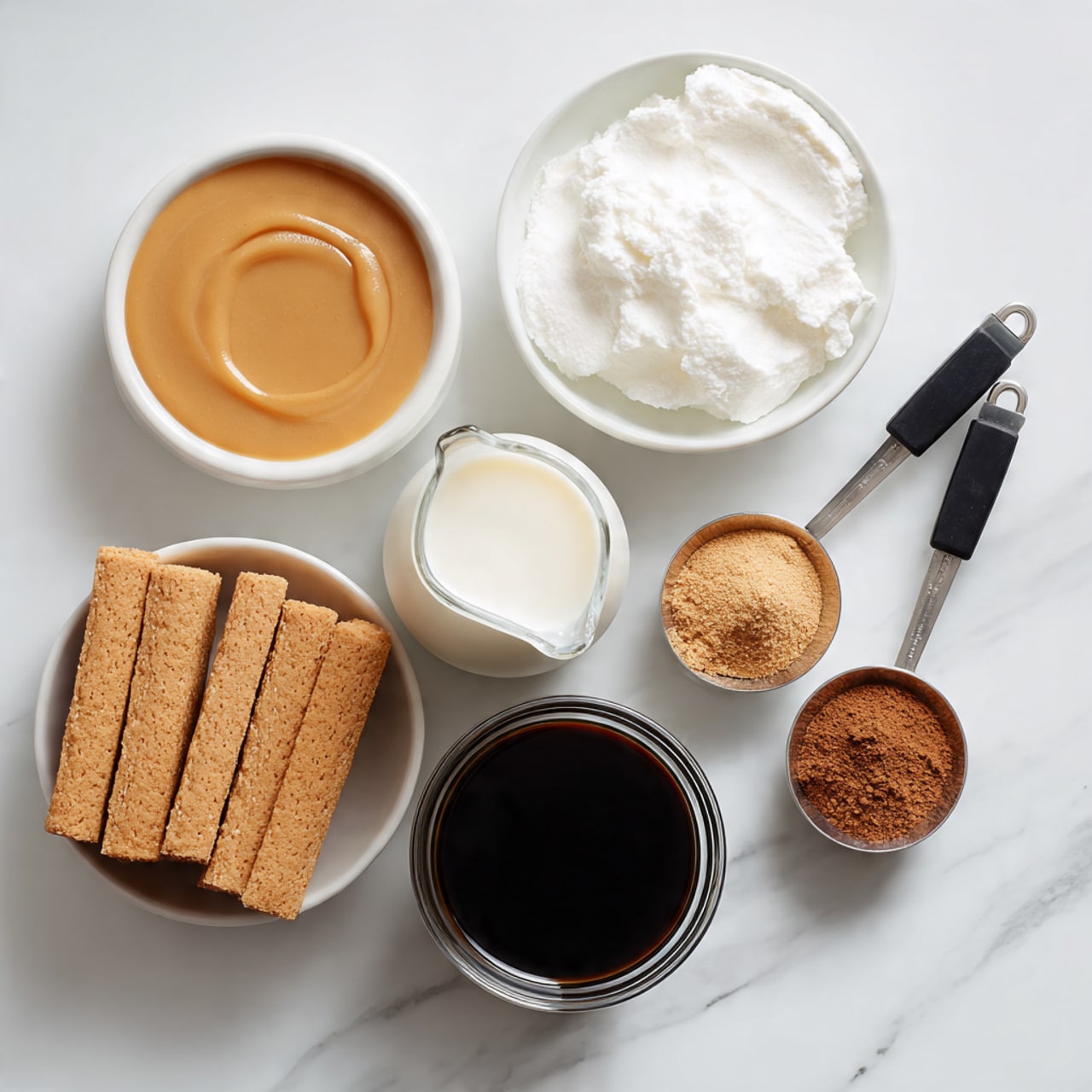 The image shows six small white dishes on a white marbled surface. In the top left, there is a small white bowl filled with light brown syrup with a smooth texture. To the right of it, a white bowl contains fluffy white cream. Next to the cream, there are three brown rectangular biscuits stacked slightly irregular. Below these, a small glass pitcher holds white milk with a smooth, liquid look. To the right of the pitcher, two black measuring spoons contain light brown and dark brown powders, placed side by side. Below the measuring spoons, a clear glass cup is filled with dark black coffee. photo taken with an iphone --ar 4:5 --v 7