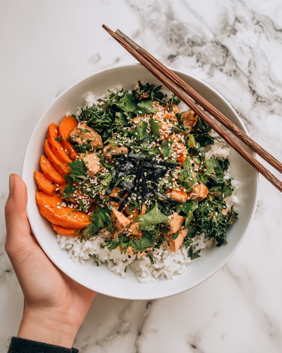 A white bowl filled with a dish having a base layer of white rice. On top of the rice, there are slices of orange-colored vegetables arranged in a circle on the left side. Green leafy vegetables and pieces of light brown tofu or cooked protein are spread over the rice, mixed together with bright green parsley or cilantro leaves scattered generously across the dish. Black and white sesame seeds are sprinkled on the top, adding texture, and a woman's hand is holding the bowl from the right side with wooden chopsticks placed diagonally on the top right edge of the bowl. The background is a white marbled surface. photo taken with an iphone --ar 4:5 --v 7