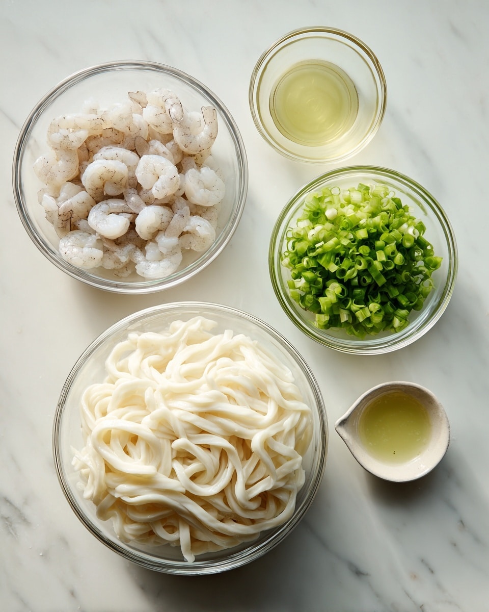 The image shows four clear glass bowls on a white marbled surface. The largest bowl in the bottom right contains a block of thick, white udon noodles with a soft, slightly shiny texture. To its top left, a medium bowl holds raw shrimp, pale with a slight pink tone and darker tails. Above that, a smaller bowl holds chopped green onions, bright green and fresh. To the right of the green onions, a tiny measuring cup contains a light yellow liquid, likely oil or broth. The arrangement is clean and simple, with natural soft lighting. photo taken with an iphone --ar 4:5 --v 7