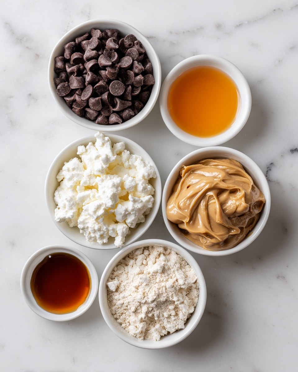 The image shows six small white bowls arranged on a white marbled surface, each holding different ingredients. At the top left is a bowl full of dark brown chocolate chips. To the right of it is a small bowl with a clear orange liquid. Below the chocolate chips is a bowl with white cottage cheese, soft and lumpy in texture. Next to it, in the center, is a bowl with light beige powder that looks dry and crumbly. On the far right is a bowl with brown peanut butter, creamy and smooth. At the bottom left corner of the image is a small bowl with a glossy dark amber liquid, possibly syrup. photo taken with an iphone --ar 4:5 --v 7