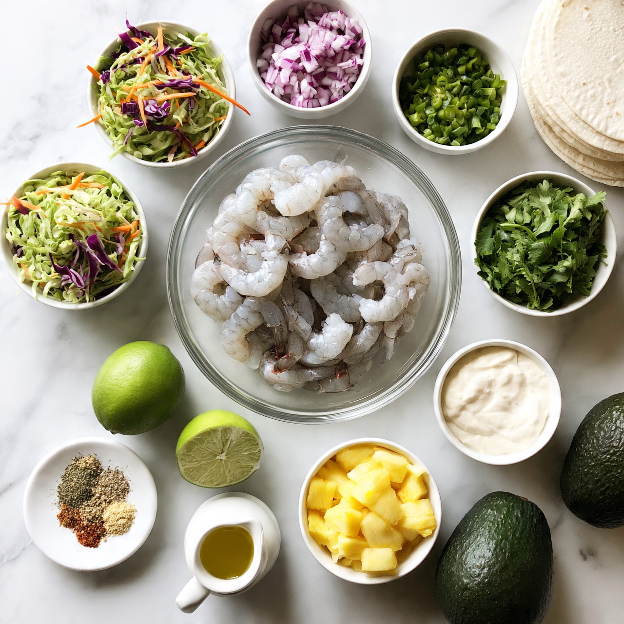 square image The image shows a clear glass bowl in the center filled with raw shrimp, pale gray and slightly translucent in color, arranged in a loose pile. Around the bowl are several small white bowls with different ingredients: shredded green and purple cabbage with thin orange carrot strips on the top right, chopped red onions in the middle left, chopped green onions on the middle right, finely chopped green peppers on the top right, and fresh green cilantro on the bottom right. Additional items include two halves of a bright green lime to the left of the shrimp, a small white bowl with a creamy white sauce near the top, a small bowl of diced yellow pineapple above the onions, and a small plate with various ground spices to the bottom left. There is also a small white pitcher with a yellowish oil and several white tortillas stacked in the bottom left corner, along with two dark green avocados on the bottom right. All items are set on a white marbled surface. Photo taken with an iphone --ar 4:5 --v 7