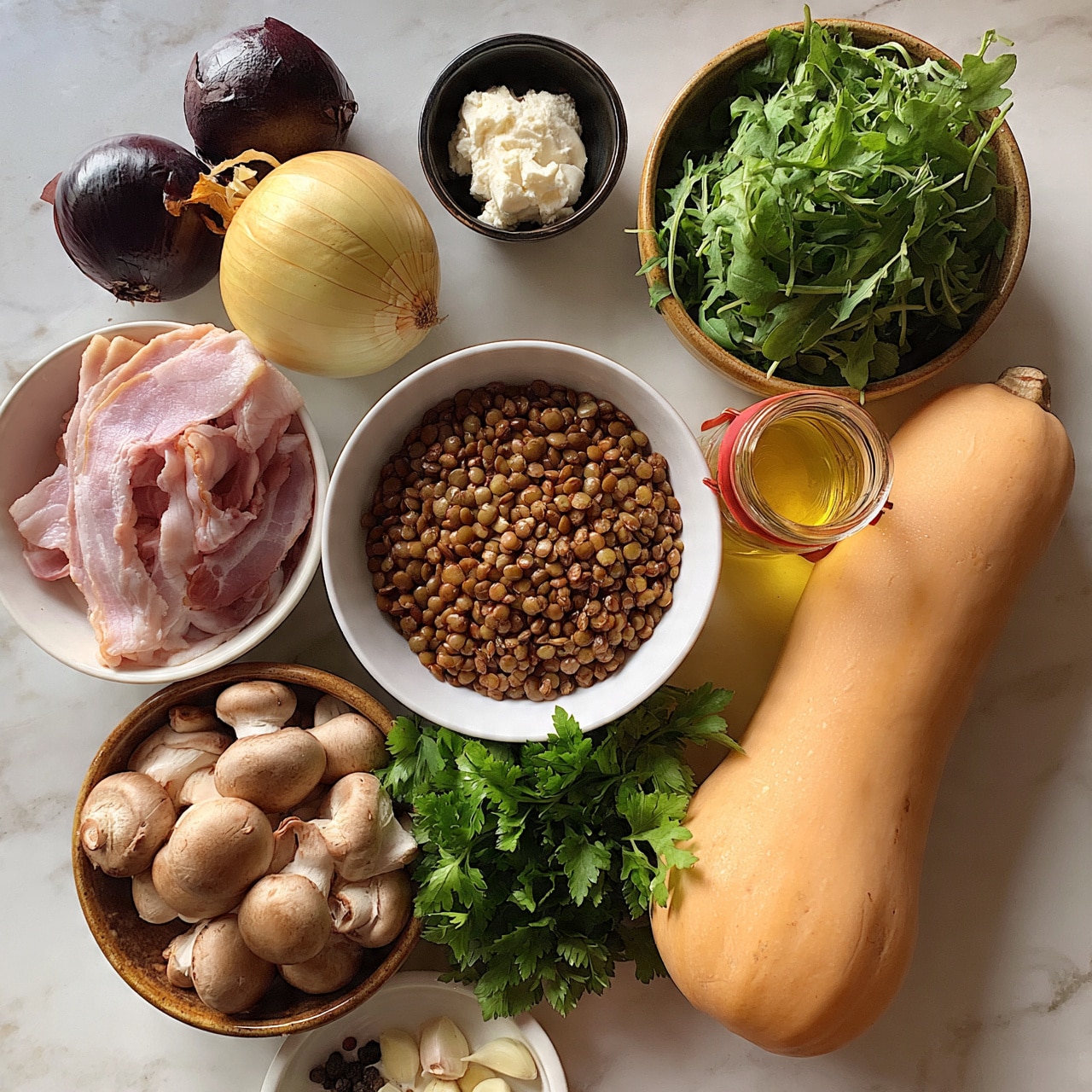 square image A white bowl filled with small, round, brown lentils is in the center. To the left, a white bowl holds pale pink bacon strips, while below it, a brown bowl is full of light brown mushrooms with smooth caps. Under the lentils is a bunch of fresh green parsley. To the right of the lentils, a long, light orange butternut squash lies horizontally. Next to it is a small glass jar with a red lid containing a yellow liquid, likely broth. Above the jar is a round brown bowl filled with fresh green leafy arugula. Near the top center is a small black bowl with soft white cheese. Above the lentils and to the left is a round yellow onion, and next to it is a dark purple onion. A small white dish near the bottom left holds garlic cloves and a few peppercorns. All items are placed on a white marbled surface photo taken with an iphone --ar 4:5 --v 7