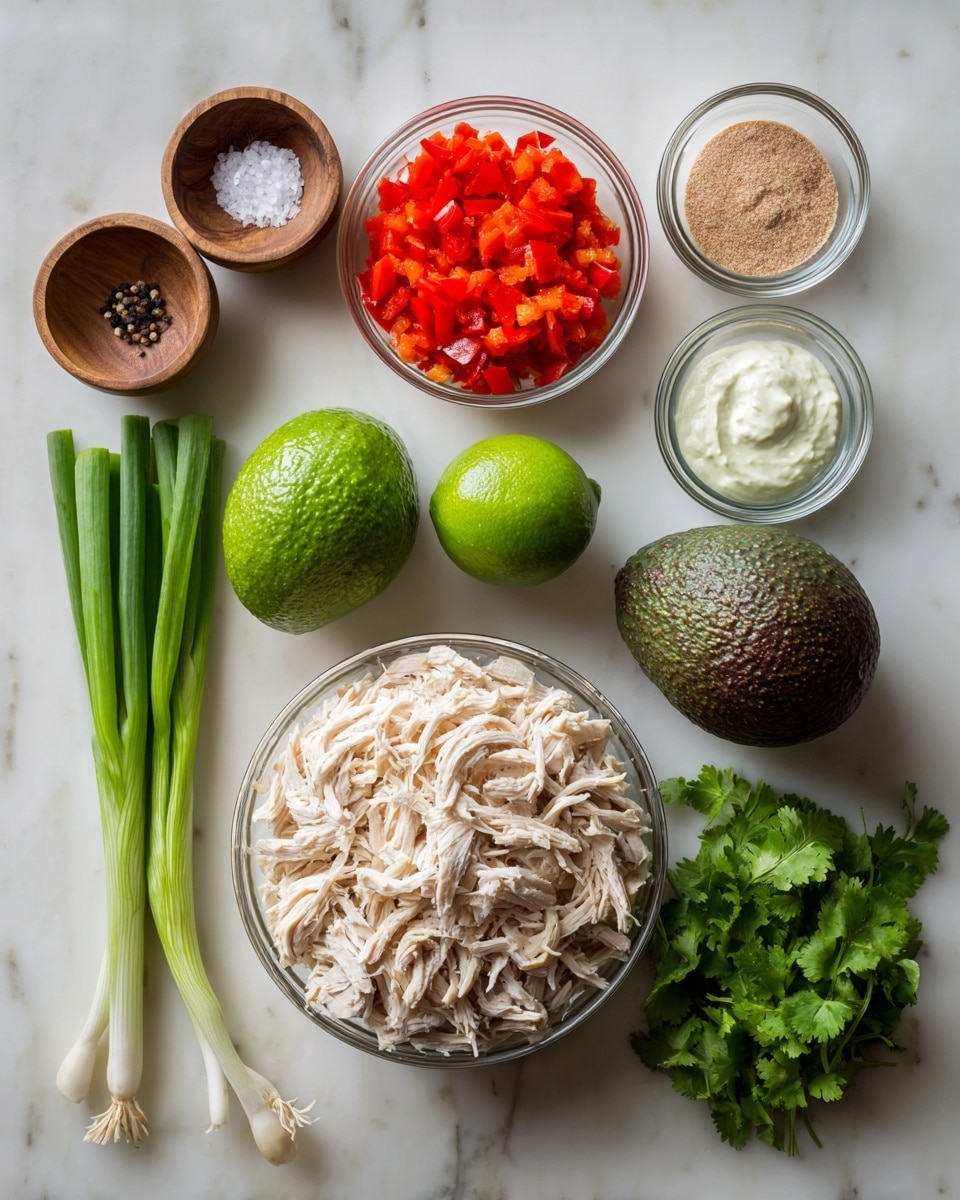 The image shows several ingredients placed neatly on a white marbled surface. At the center bottom is a clear bowl filled with shredded pale chicken. To the top right of it, three small clear bowls are arranged vertically: the top one has white cream with a light tan powder, the middle one is filled with bright red diced bell peppers, and the bottom one contains a dark reddish-brown paste. Above these, there is a whole avocado with a rough dark green skin and next to it a bright green lime. To the left of the chicken bowl are three whole green onions with white bases and long green tops, and below these is a small bunch of green cilantro leaves. On the far left side, two small wooden bowls sit vertically, the top holding coarse black pepper and the bottom holding coarse white salt. Photo taken with an iphone --ar 4:5 --v 7