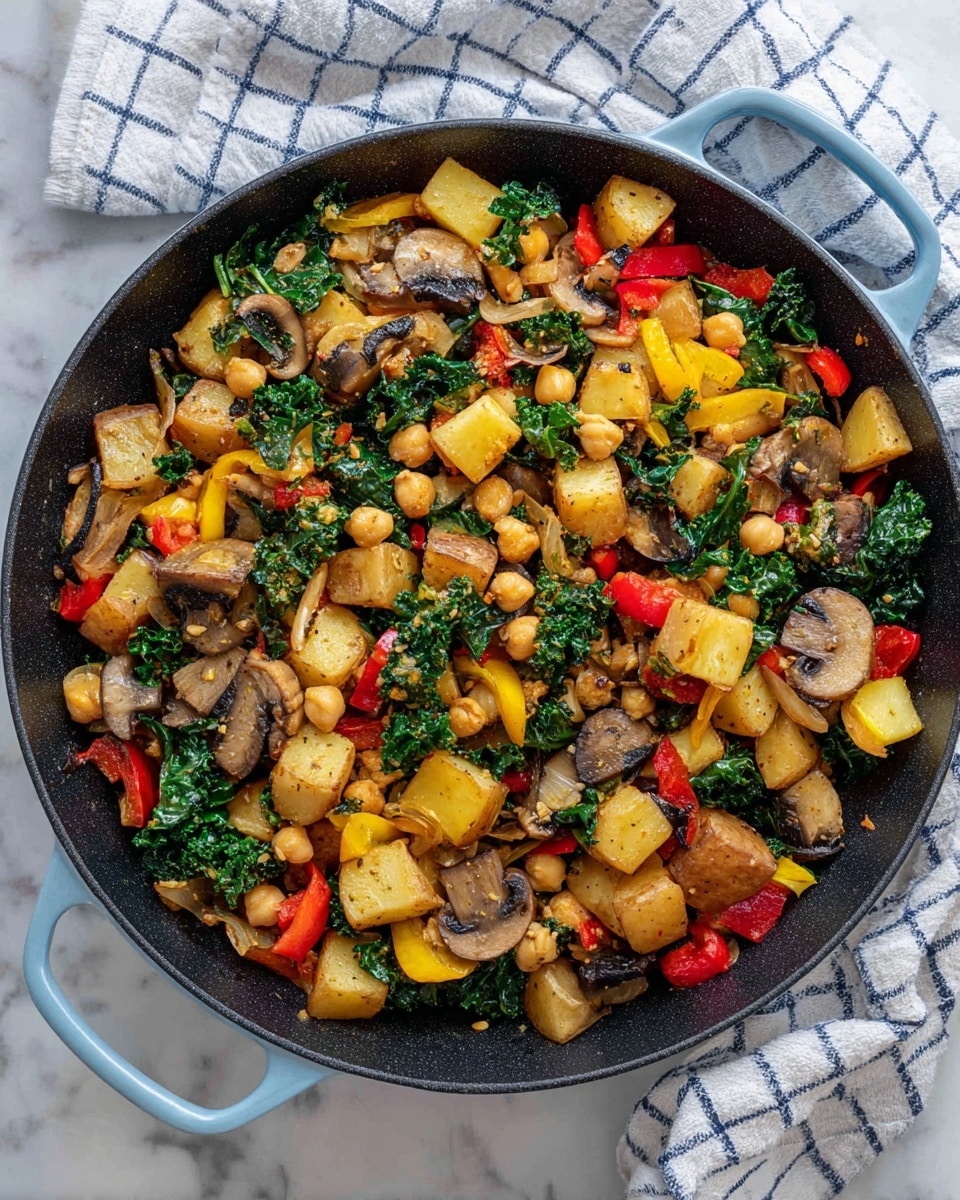 A large black skillet filled with a colorful mix of sautéed vegetables including light brown cubed potatoes, yellow summer squash pieces, red bell pepper chunks, dark brown sliced mushrooms, green kale leaves, and beige chickpeas scattered throughout. The skillet has light blue handles and rests on a white marbled surface with a white and blue checkered cloth in the background. The textures of the vegetables appear soft and cooked, with the kale adding a fresh leafy contrast. photo taken with an iphone --ar 4:5 --v 7
