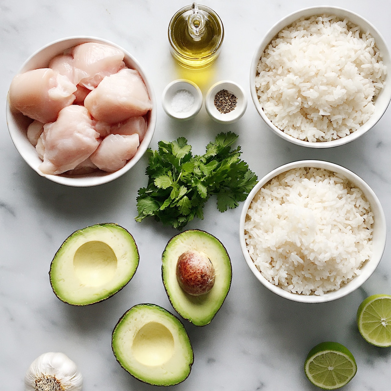 square image The image shows a top view of various ingredients arranged on a white marbled surface, including two white bowls filled with white rice placed on the right side, one larger than the other. Towards the upper left, there is a white bowl filled with chunks of raw light pink chicken. There are three avocado halves positioned in the lower center area, two without pits and one with a brown pit still inside. A bunch of fresh green cilantro sits near the middle. On the top center, there is a small amount of golden olive oil in a glass container and below it, two small white bowls containing salt and spices. A couple of lime halves are placed on the lower right. A garlic bulb is near the bottom left corner. Photo taken with an iphone --ar 4:5 --v 7