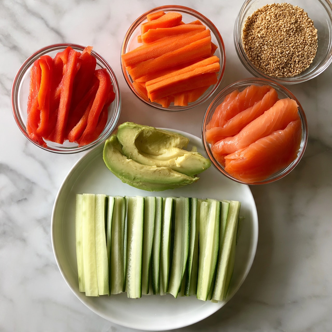 square image The image shows a white round plate with thin, long, pale green cucumber slices neatly lined up side by side, forming the first layer. Around the plate on a white marbled surface, there are five small clear glass bowls, each containing different ingredients: bright red bell pepper strips, vivid orange carrot sticks, pale green avocado slices with soft texture, salmon pink slices of smoked salmon, and a bowl filled with light brown sesame seeds. The arrangement is clean and organized with each element clearly separated. Photo taken with an iphone --ar 4:5 --v 7