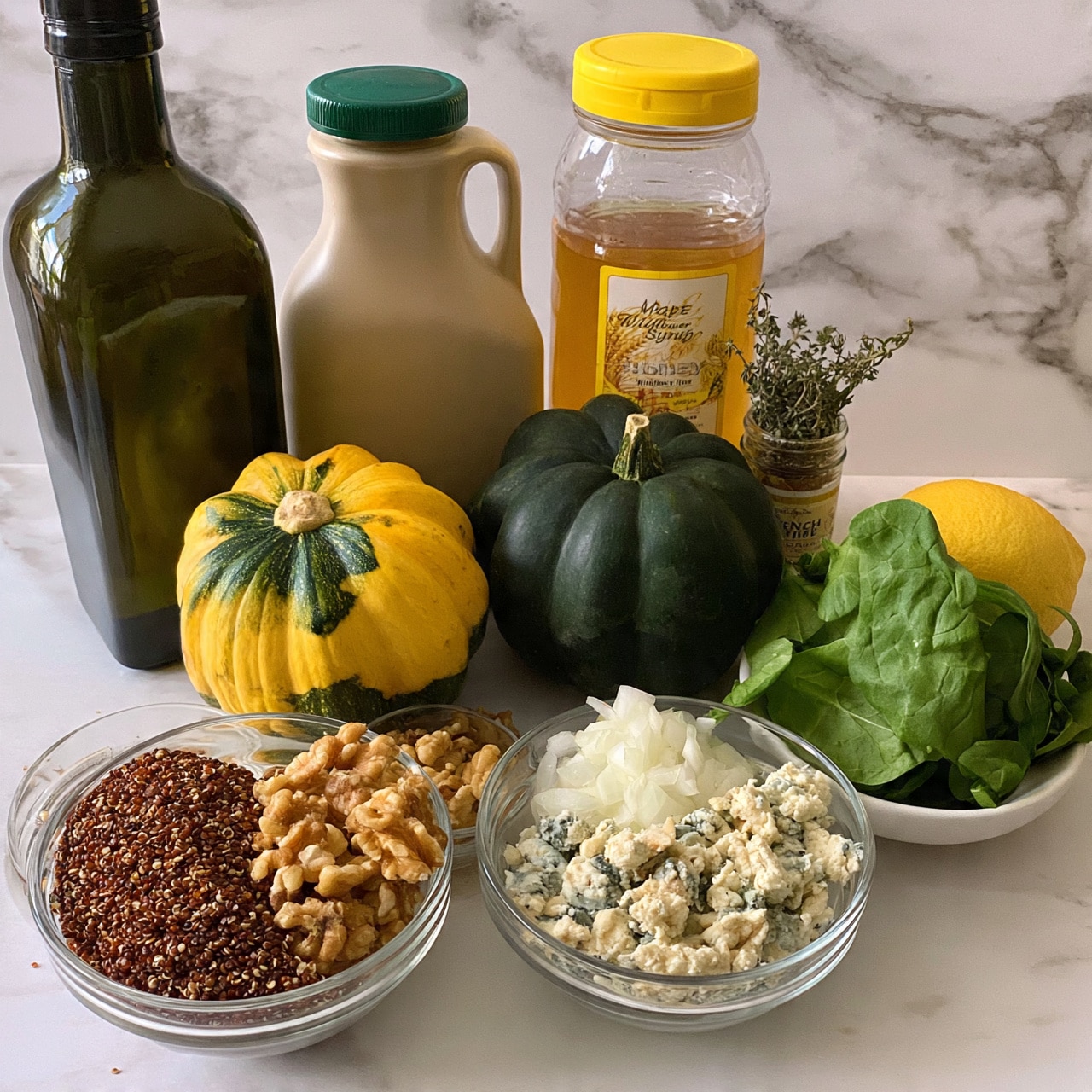 square image The image shows various cooking ingredients placed on a white marbled surface. There are two round squash, one yellow with green patches and one dark green, positioned in the middle. Behind them, from left to right, there is a large dark green bottle of avocado oil, a beige jug of maple syrup with a green lid, and a clear plastic bottle of wildflower honey with a yellow lid. In front of these, there are four clear glass bowls: one with red quinoa, one with walnut pieces, one with chopped white onions, and one with crumbled blue cheese. To the right of the bowls, there is a small white bowl filled with fresh green spinach leaves and a whole yellow lemon beside it. A small jar of French thyme spice stands next to the honey bottle. The background is white with marble texture. photo taken with an iphone --ar 4:5 --v 7