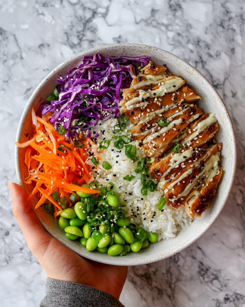 The image shows a bowl filled with three main layers. The bottom layer is white rice, soft and fluffy. On top of the rice, there is a mix of colorful vegetables including shredded purple cabbage, thin orange carrot strips, bright green edamame beans, and chopped green onions, all giving a fresh, crunchy look. On one side of the bowl, there are sliced pieces of grilled chicken with a shiny, brown glaze and drizzled with a light sauce. The chicken is sprinkled with white and black sesame seeds. The bowl is white with a subtle texture, and the background has a white marbled surface with a woman’s hand holding the bowl from the side. Photo taken with an iphone --ar 4:5 --v 7