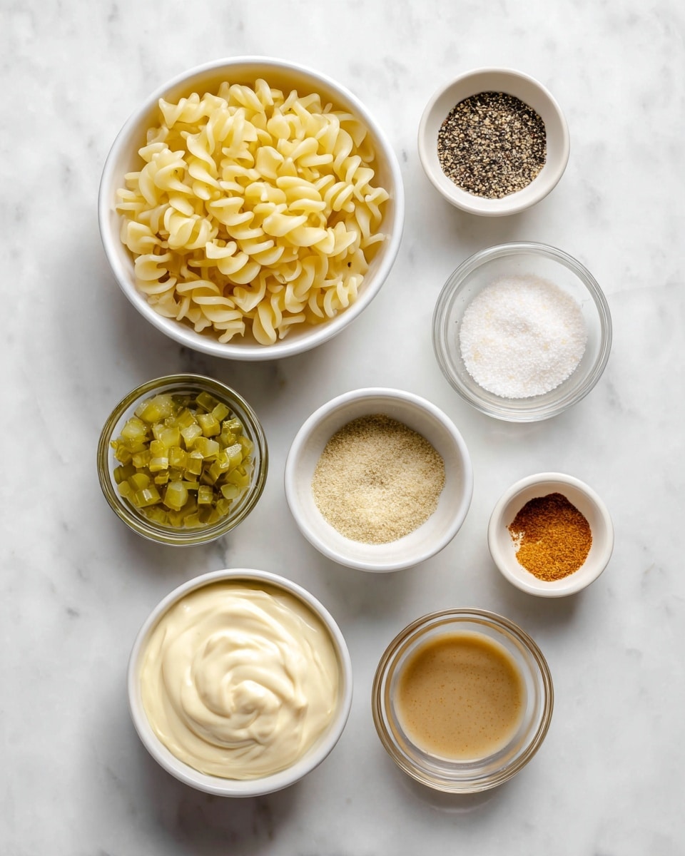 The image shows eight small white and clear bowls arranged neatly on a white marbled surface. The largest white bowl on the left holds uncooked twisted pasta in a light yellow color, filling the bowl. To its right, a small white bowl contains a mix of salt and black pepper in a side-by-side arrangement. Below that, a clear bowl holds finely chopped green pickles. Next to it, on the right, is another clear bowl with a fine black pepper mix. Above the pickles, a clear bowl contains a light orange powder. Below the pepper, a small clear bowl holds a smooth mustard-colored paste. A clear bowl near the bottom center has a light brown liquid, while a white bowl next to it contains thick, creamy mayonnaise with soft swirling in the texture. In the bottom left corner, a small white bowl holds white granulated sugar. The clean and organized layout emphasizes the different textures and colors of the ingredients in a neat and simple way. photo taken with an iphone --ar 4:5 --v 7