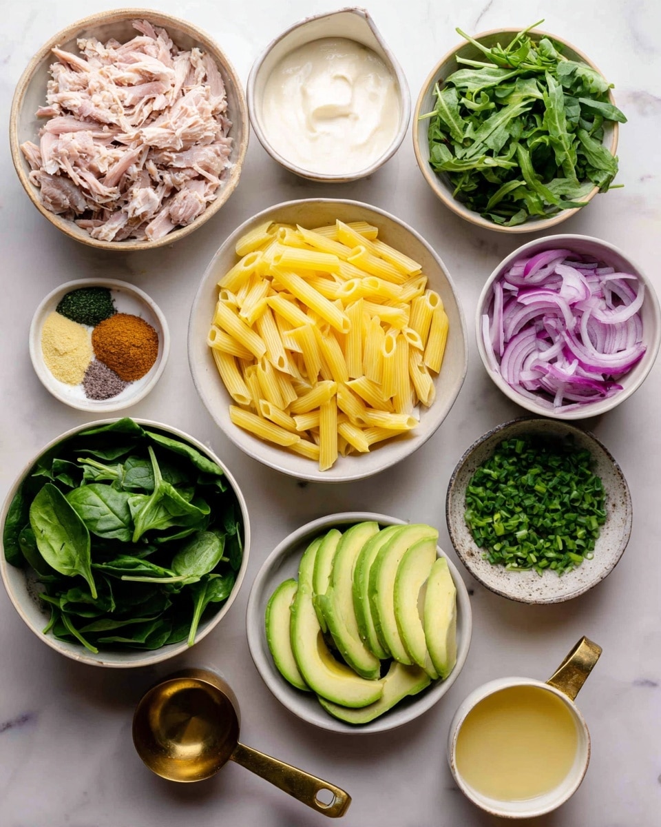 Green Pasta Salad with Edible Flowers and Lemon Herb Dressing Recipe 4 The image shows several white bowls arranged on a white marbled surface, each filled with different ingredients: yellow penne pasta in the center, shredded light pink meat in the bowl to the left, sliced pale green avocado at the bottom right, bright green spinach leaves in a bowl at the bottom left, dark green arugula in a bowl near the bottom center, bright green chopped chives in a bowl near the top right, green parsley leaves in a bowl near the top center, and sliced purple and white onions in a bowl near the top left. There are also two small white bowls containing brown and yellow powders, and two brass measuring cups with handles, one filled with white creamy yogurt and the other with a beige sauce. A small cup of light yellow liquid is placed near the bottom right. Photo taken with an iphone --ar 4:5 --v 7
