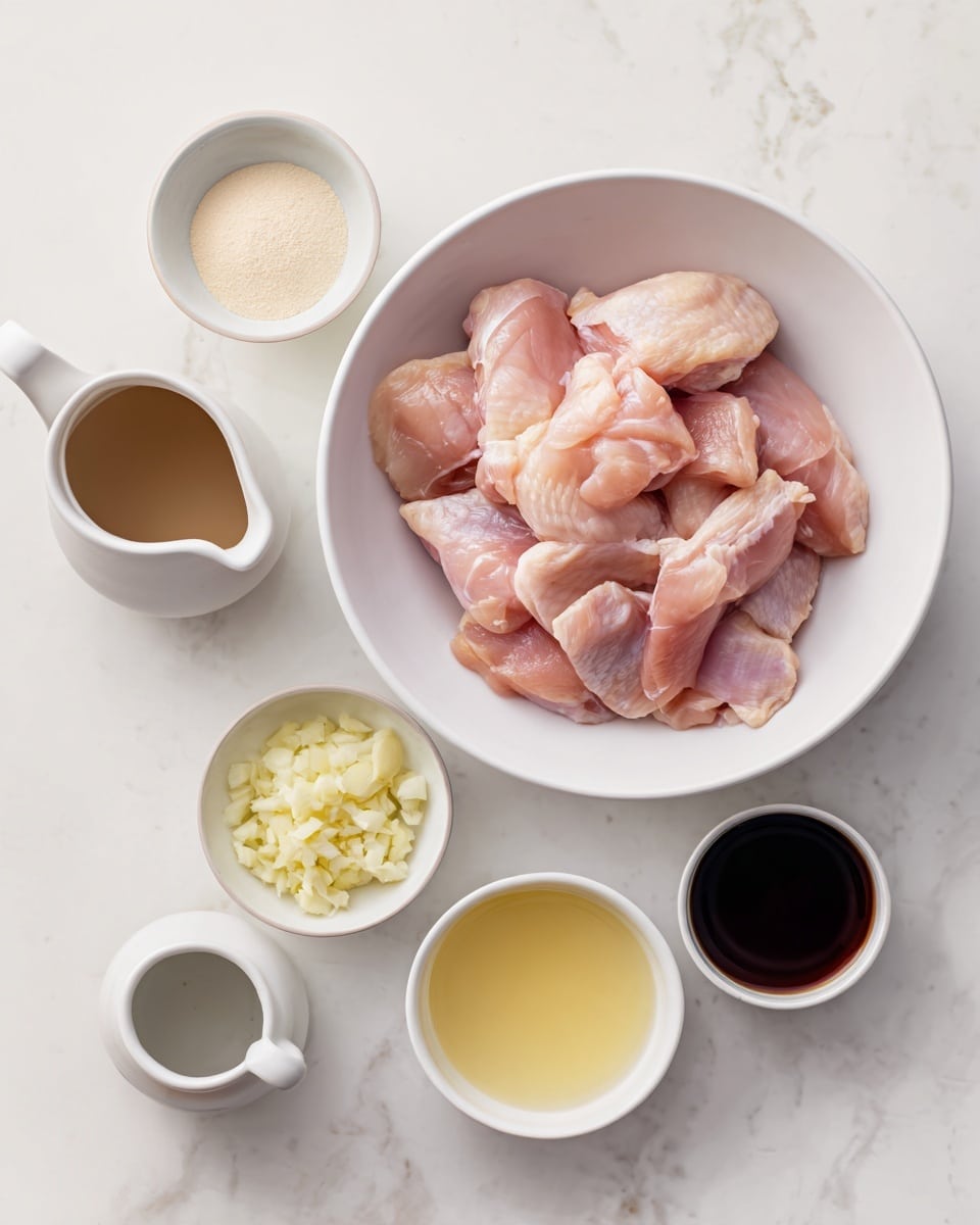 A white bowl is filled with raw pink chicken pieces with smooth surfaces and small folds, placed at the top center on a white marbled surface. Around it are five small white cups arranged mostly in a semi-circle: one on the left contains light beige powder, below it is a small white pitcher with a brown liquid, at the center bottom is finely chopped pale yellow garlic in a bowl, to the right is a bowl with a dark brown liquid, next to it is a bowl with a yellowish liquid, and below all is an empty white cup. The arrangement is neat and minimal. Photo taken with an iphone --ar 4:5 --v 7