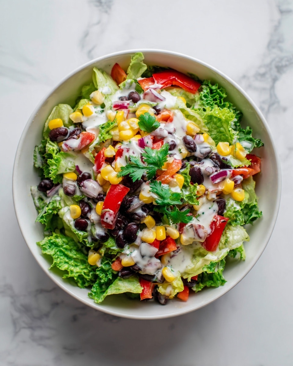 A white bowl filled with a colorful salad showing multiple layers: a base of fresh green lettuce leaves with a slightly ruffled texture, mixed with bright yellow corn kernels scattered throughout. There are black beans spread evenly across, adding a dark contrast. Chunks of red bell pepper and small pieces of light pink onion are mixed in, giving bursts of color. The salad is lightly dressed with a creamy white sauce, with some small green parsley leaves sprinkled on top for garnish. The bowl is placed on a white marbled surface. Photo taken with an iphone --ar 4:5 --v 7