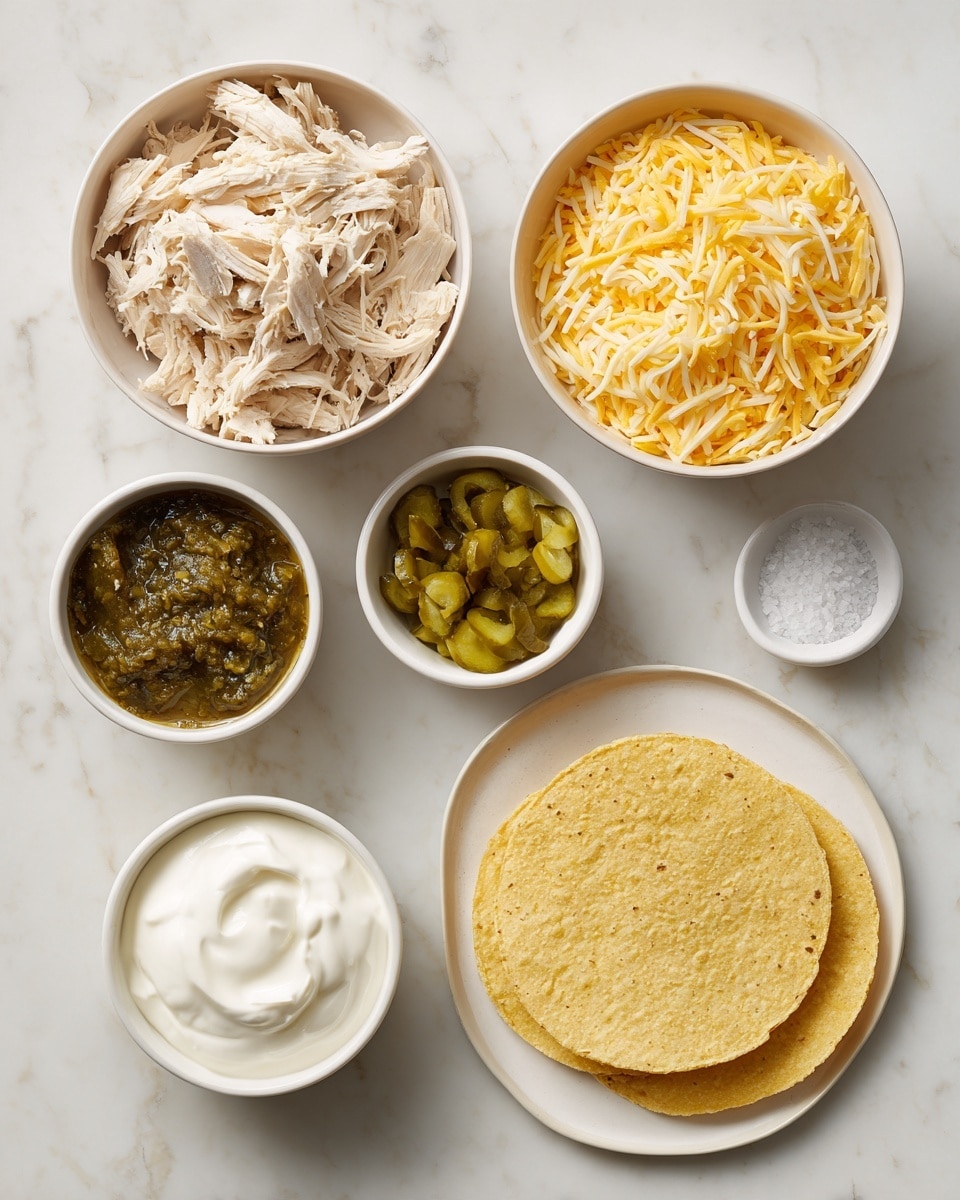 The image shows six white bowls and a white plate arranged on a white marbled surface. On the top left is a bowl of shredded light beige chicken, next to it on the right is a bowl filled with yellow shredded cheese. Below the chicken is a small white bowl with chopped green pickles, and next to it on the right is a bowl with dark green salsa. At the bottom left is another bowl with white sour cream. On the right side of the image is a white plate holding three yellow corn tortillas stacked with their edges overlapping. A pinch of coarse salt is on the plate near the tortillas. The overall look is neat and colorful, with each ingredient clearly separated. photo taken with an iphone --ar 4:5 --v 7