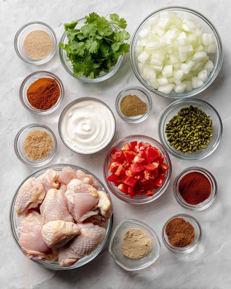 The image shows multiple clear glass bowls arranged on a white marbled surface, each containing different cooking ingredients. On the bottom left is a large bowl filled with raw chicken pieces with smooth pale pink skin. To its right, there are smaller bowls containing white yogurt, light brown ground spices, bright green chopped chilies with visible seeds, pale beige minced garlic, and white salt. Above these are more small bowls holding light brown seeds, dark red powder, cinnamon brown powder, and a medium bowl of bright red diced tomatoes with a juicy texture. On the top right is a large bowl filled with small white onion cubes showing a crisp texture. On the top left is a medium bowl of fresh green cilantro leaves. The bowls are neatly spaced out, creating a colorful and organized view of raw cooking ingredients. Photo taken with an iphone --ar 4:5 --v 7