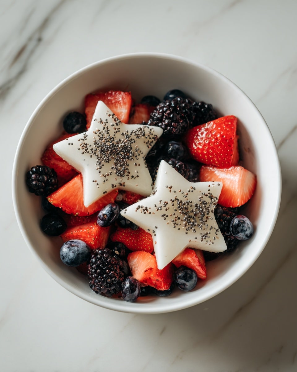 A white bowl filled with a colorful fruit mix sits on a white marbled surface. The bottom layer includes small dark blueberries and blackberries, creating a deep color base. On top, there are bright red strawberry pieces, some sliced into halves and quarters, adding freshness and contrast. Two large white star-shaped slices, sprinkled lightly with black seeds, rest on top of the strawberries and berries, standing out vividly against the darker fruits. The image captures the fresh and healthy arrangement clearly, photo taken with an iphone --ar 4:5 --v 7